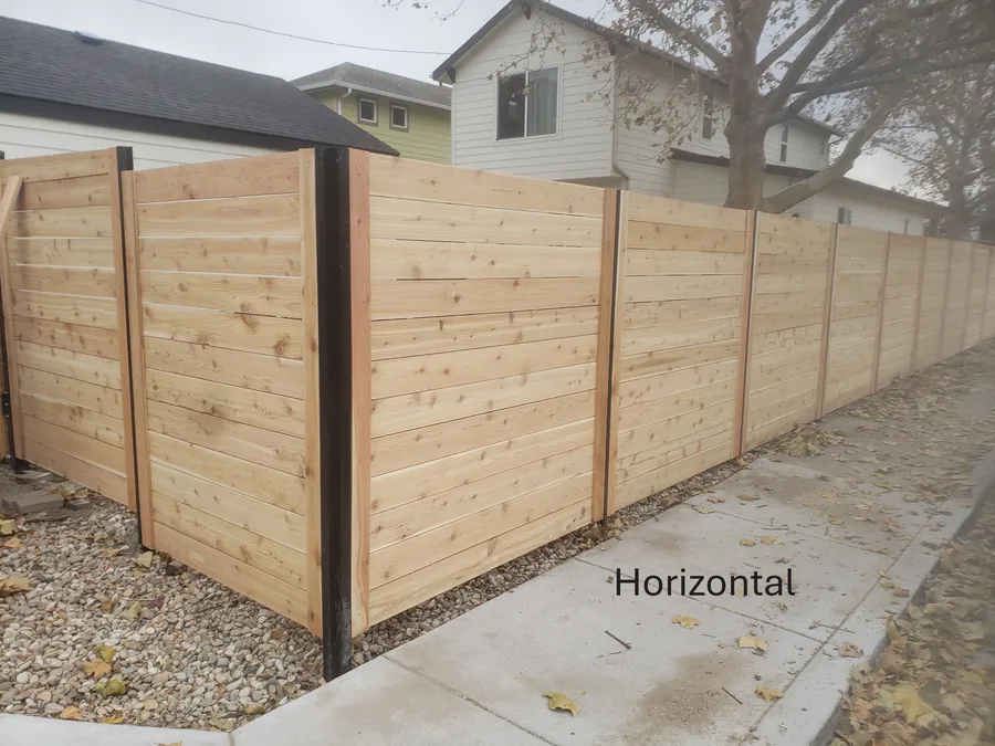 Horizontal cedar fence with black steel posts between two homes in Meridian, Idaho
