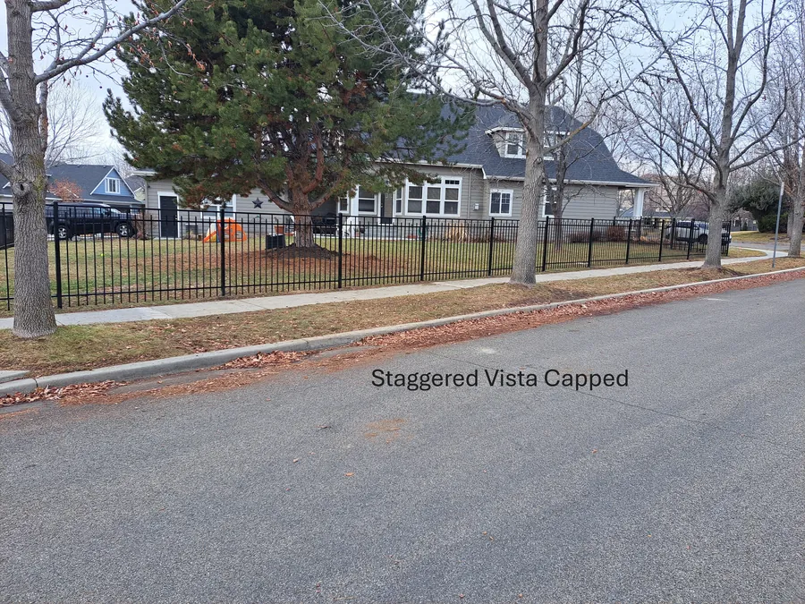 Staggered vista capped wrought iron fence in front of a historic Boise home